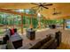 Covered back porch with wood floors, comfortable seating, and picturesque views of the lush backyard and serene lake at 125 Mayo Rd, Covington, GA 30014