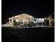 Night view of a home featuring a large deck, outdoor seating, and stairs leading to the yard at 125 Mayo Rd, Covington, GA 30014