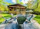 Backyard featuring a large, stamped concrete patio with a custom stone firepit and beautiful views of the surrounding landscape at 125 Mayo Rd, Covington, GA 30014