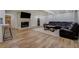 Finished basement featuring wood-look floors, a stone fireplace, and a comfortable leather sectional sofa at 125 Mayo Rd, Covington, GA 30014