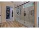 Luxurious bathroom featuring a walk-in shower, wood look tile flooring, and a walk-in closet at 125 Mayo Rd, Covington, GA 30014
