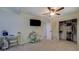 Bedroom featuring a ceiling fan, neutral carpet, and dedicated study area with a wardrobe or closet at 125 Mayo Rd, Covington, GA 30014