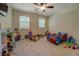 Bedroom featuring a ceiling fan, neutral carpet, and plenty of space for children to play and explore at 125 Mayo Rd, Covington, GA 30014