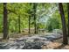 Home exterior with a long driveway, surrounded by mature trees, offering both privacy and a sense of seclusion at 125 Mayo Rd, Covington, GA 30014