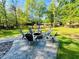Lake property featuring an outdoor stone firepit area with seating and lovely views of the lake and surrounding woods at 125 Mayo Rd, Covington, GA 30014
