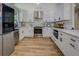 Well-appointed kitchen with stainless steel appliances, white cabinets, and a functional layout for cooking and dining at 125 Mayo Rd, Covington, GA 30014