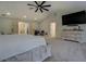 Bright main bedroom with a tray ceiling, a ceiling fan, and carpeted floors at 125 Mayo Rd, Covington, GA 30014