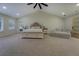 Bright main bedroom featuring vaulted ceilings, a ceiling fan, and a door to the outdoors at 125 Mayo Rd, Covington, GA 30014