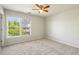 Neutral bedroom with carpet, ceiling fan, and a large window offering a neighborhood view at 1605 Gilstrap Nw Ln, Atlanta, GA 30318