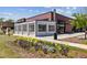 Charming building exterior with floral landscaping at The Woodall in Westside Village at 1605 Gilstrap Nw Ln, Atlanta, GA 30318