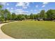 Expansive community green space with walking path, lush grass, trees, and plantings at 1605 Gilstrap Nw Ln, Atlanta, GA 30318