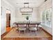 Dining room features modern lighting, wainscoting, and neutral decor for sophisticated gatherings at 1605 Gilstrap Nw Ln, Atlanta, GA 30318