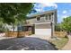 Home exterior showing the driveway, garage, basketball hoop, and fenced-in backyard at 1605 Gilstrap Nw Ln, Atlanta, GA 30318