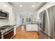 Modern kitchen featuring stainless steel appliances, white cabinets, and hardwood floors, designed for culinary enthusiasts at 1605 Gilstrap Nw Ln, Atlanta, GA 30318