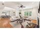 Open concept living room with dining area boasts lots of natural light and hardwood floors at 1605 Gilstrap Nw Ln, Atlanta, GA 30318