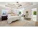 Spacious main bedroom with a tray ceiling, soft carpet, and a sitting area is filled with natural light at 1605 Gilstrap Nw Ln, Atlanta, GA 30318
