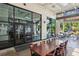 An outdoor patio featuring a long wooden table, black chairs, and large glass windows at 1605 Gilstrap Nw Ln, Atlanta, GA 30318