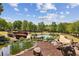 Scenic pond area with a bridge and landscaped rocks, bushes and walking path at 1605 Gilstrap Nw Ln, Atlanta, GA 30318