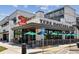 The Ted's Montana Grill featuring outdoor seating with green umbrellas and ample parking at 1605 Gilstrap Nw Ln, Atlanta, GA 30318