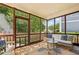 Inviting screened porch with stone flooring and comfortable seating, perfect for enjoying the outdoors at 1605 Gilstrap Nw Ln, Atlanta, GA 30318
