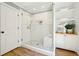Modern shower featuring a glass enclosure, built-in niche, bench, and stylish tile work at 1605 Gilstrap Nw Ln, Atlanta, GA 30318