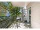 Balcony boasts black metal railing, white brick, and overlooks a tree-lined neighborhood at 3648 Peachtree Ne Rd # 2Q, Atlanta, GA 30319