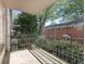 Balcony with decorative metal railing overlooks a lush, wooded neighborhood at 3648 Peachtree Ne Rd # 2Q, Atlanta, GA 30319