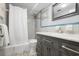 Bathroom features a vanity with marble top, grey tiling, and a shower with a white shower curtain at 3648 Peachtree Ne Rd # 2Q, Atlanta, GA 30319