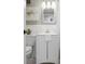 Bathroom features a white vanity, toilet, mirror, and floral arrangement at 3648 Peachtree Ne Rd # 2Q, Atlanta, GA 30319