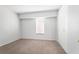 Carpeted bedroom features white walls, white trim, a window, and closet space at 3648 Peachtree Ne Rd # 2Q, Atlanta, GA 30319