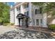 Elegant building entrance with columns, covered awning, and brick walkway at 3648 Peachtree Ne Rd # 2Q, Atlanta, GA 30319