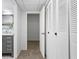 Hallway featuring grey paint, a doorway, and closet with shuttered doors and black hardware at 3648 Peachtree Ne Rd # 2Q, Atlanta, GA 30319