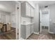 Hallway with gray cabinets and countertops connecting the kitchen, living, and dining areas at 3648 Peachtree Ne Rd # 2Q, Atlanta, GA 30319