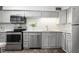Charming kitchen featuring stainless steel appliances, gray cabinets, and sleek countertops at 3648 Peachtree Ne Rd # 2Q, Atlanta, GA 30319