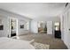 Expansive main bedroom with large windows and a view into the living room at 3648 Peachtree Ne Rd # 2Q, Atlanta, GA 30319