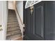 Townhome entrance showcasing a staircase with carpeted steps and a classic front door with a knocker at 375 Highland Ne Ave # 1011, Atlanta, GA 30312