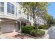 Inviting townhome exteriors with well-maintained landscaping and attached garages on a sunny day at 375 Highland Ne Ave # 1011, Atlanta, GA 30312