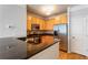 Modern kitchen with stainless steel appliances, granite countertops, and warm wood cabinetry at 375 Highland Ne Ave # 1011, Atlanta, GA 30312