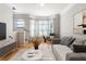 Comfortable living room featuring hardwood floors, modern furnishings, and abundant natural light at 375 Highland Ne Ave # 1011, Atlanta, GA 30312