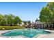 Community pool surrounded by lush landscaping, mature trees, and seating at 375 Highland Ne Ave # 1011, Atlanta, GA 30312