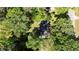 Aerial shot showcasing the wooded lot surrounding the property with a well-maintained roof at 4257 Webb Rd, Tucker, GA 30084