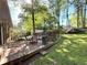 Cozy backyard deck with outdoor seating, a grill, and a serene garden setting at 4257 Webb Rd, Tucker, GA 30084