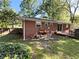 View of brick home from yard, including patio area perfect for outdoor grilling and relaxing at 4257 Webb Rd, Tucker, GA 30084