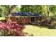 Brick home with a spacious backyard, wooden deck, patio furniture, and well-maintained lawn at 4257 Webb Rd, Tucker, GA 30084
