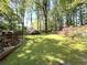 A spacious, wooded backyard featuring mature trees, green grass, and a tranquil atmosphere at 4257 Webb Rd, Tucker, GA 30084
