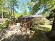 Inviting backyard featuring a wooden deck, brick home exterior, and lush, mature landscaping at 4257 Webb Rd, Tucker, GA 30084