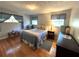 Cozy bedroom features hardwood floors, bright windows, and relaxing decor at 4257 Webb Rd, Tucker, GA 30084