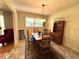 The dining room offers natural light, wood floors, and wainscotting on the walls at 4257 Webb Rd, Tucker, GA 30084