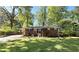 Front exterior of a brick house with mature trees and lush green lawn at 4257 Webb Rd, Tucker, GA 30084