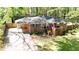 Aerial view of brick home with lush green lawn, mature trees, and a long driveway at 4257 Webb Rd, Tucker, GA 30084